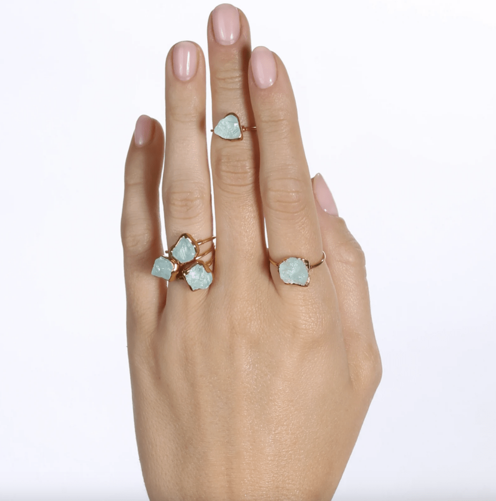 Raw aquamarine stone set in a gold ring for Pisces birthstone